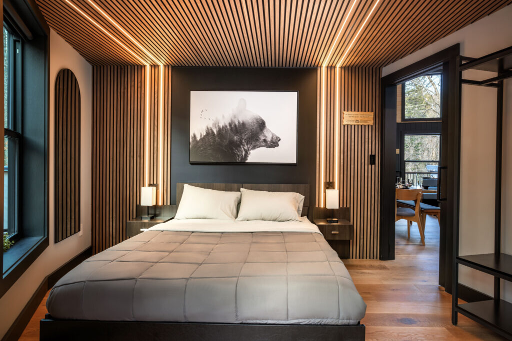 Bedroom 1 with queen bed, LED wood slat wall, bear artwork, USB-C ports, adjustable pillows and mirror closet system - Mount Snow Yurt